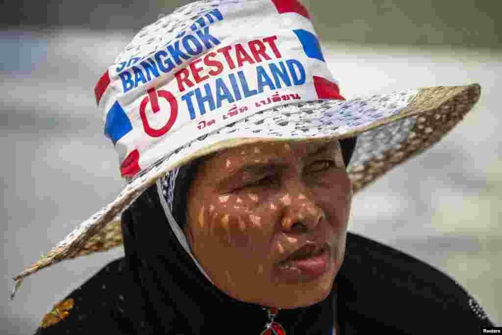 An anti-government protester gathers with others during a rally at the Shinawatra building in central Bangkok, March 7, 2014.