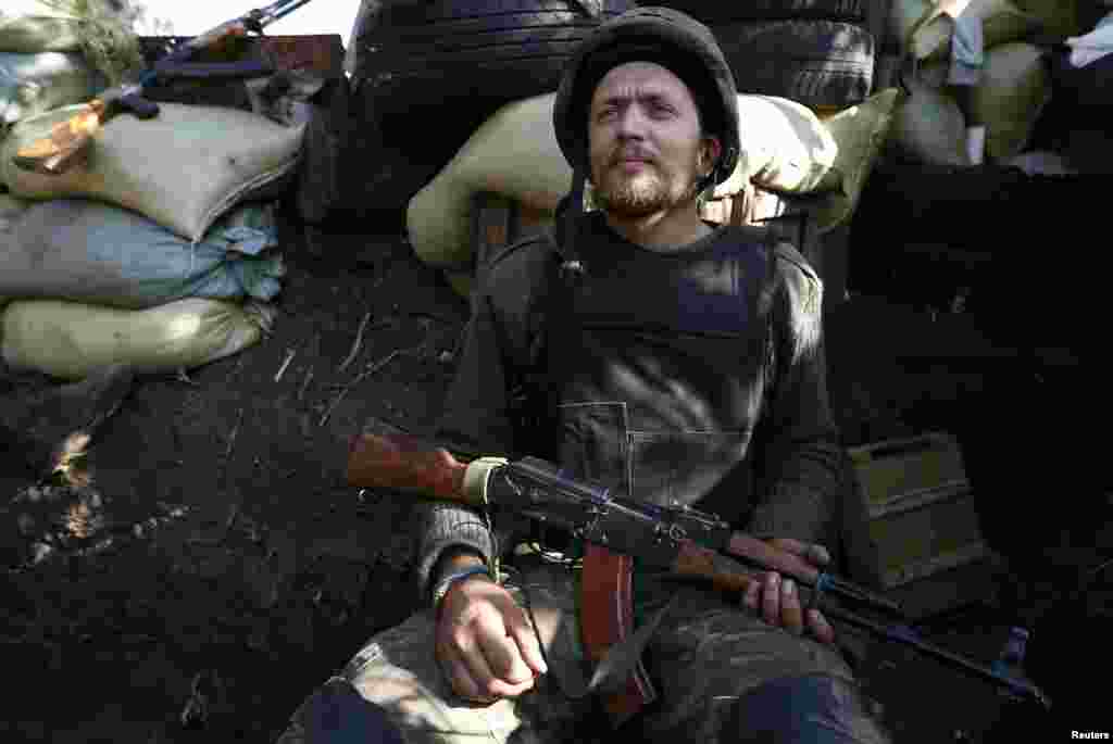A Ukrainian serviceman sits at his entrenchment near Donetsk, Sept. 16, 2014.