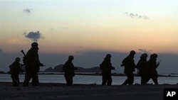South Korean Marines patrol along a beach on Yeonpyeong Island, South Korea, 15 Dec 2010
