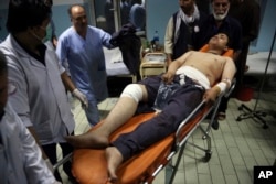An injured man is brought in to a hospital following a deadly attack in Kabul, Afghanistan, Sept. 5, 2018.