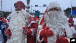 Finland's Santa, right, and Russia's Grandfather Frost meet at the two countries busiest joint border crossing in Nuijamaa, Finland, Dec. 19, 2016, as an annual show of goodwill and neighborly friendship.