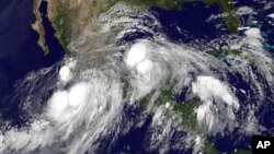 FILE - Hurricane Ingrid in the Gulf of Mexico approaching the coast of Mexico and tropical storm Manuel just off the western coast of Mexico, 15, 2013. 