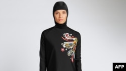 In a recent undated handout picture released by British retailer Marks and Spencer, April 8, 2016, a model poses wearing one of Marks and Spencer's full-body bathing suit or burkini suit.