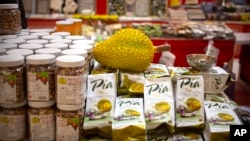 FILE - A reproduction of a durian sits atop packages of durian cakes from Vietnam at a "Belt and Road Products New Year's Marketplace" at a shopping mall in Beijing, Jan. 10, 2020.