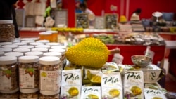 FILE: A reproduction of a durian sits atop packages of durian cakes from Vietnam at a "Belt and Road Products New Year's Marketplace" at a shopping mall in Beijing, Jan. 10, 2020.