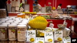 FILE - A reproduction of a durian sits atop packages of durian cakes from Vietnam at a shopping mall in Beijing, Jan. 10, 2020. In September 2022, Vietnam exported its first fresh durian to China after four years of negotiations.