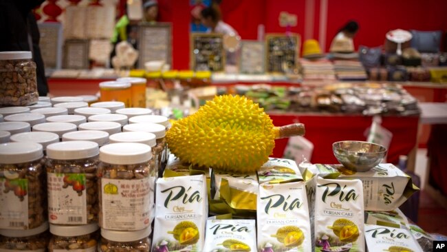 FILE - A reproduction of a durian sits atop packages of durian cakes from Vietnam at a