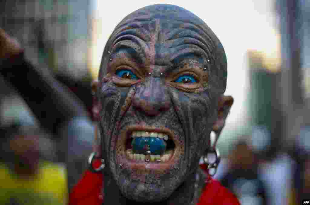 A tattooed runner gestures before the start of the 95rd 15-km Sao Silvestre international race in Sao Paulo, Brazil.