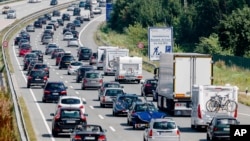 FILE - In this July 24, 2016 file photo drivers are stuck in a traffic jam on highway A 1 near to Bad Oldesloe in Germany. 