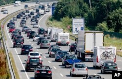 FILE - Drivers are stuck in a traffic jam near Bad Oldesloe in Germany, July 24, 2016. A study released at that time showed greenhouse gas emissions in the European Union had risen in 2015, the first increase since 2010.