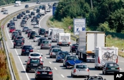 FILE - In this July 24, 2016 file photo drivers are stuck in a traffic jam on highway A 1 near to Bad Oldesloe in Germany.