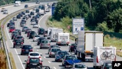 FILE - In this July 24, 2016 file photo drivers are stuck in a traffic jam on highway A 1 near to Bad Oldesloe in Germany. 