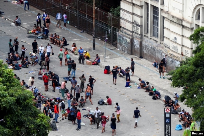 People are seen in the area known as the "flow" where people buy and use drugs in an area known as "cracolandia," or crackland, a dangerous wasteland of about eight blocks in the historic center of Sao Paulo, Brazil, March 9, 2021. REUTERS/Amanda Perobell