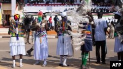 South Sudanese dance and wave flags during celebrations marking three years of Independence at a stadium in Juba, July 9, 2014. 