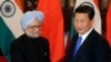 China's President Xi Jinping (R) shakes hands with India's Prime Minister Manmohan Singh before their meeting at the Diaoyutai State Guesthouse in Beijing October 23, 2013. REUTERS/Peng Sun/Pool (CHINA - Tags: POLITICS) - RTX14KSF