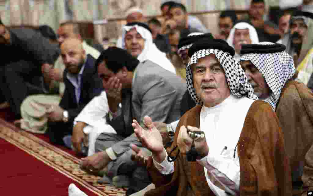 Worshippers attend joint Sunni-Shiite Friday prayers in a Sunni mosque amid tight security measures in Baghdad, Iraq.