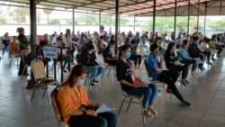 Hundreds of garment workers returning to Phnom Penh after visiting the provinces for the Khmer New Year celebration are mandated for a health checkup at Chumpou Vorn high school, in Phnom Penh, Cambodia, April 20, 2020. (Nem Sopheakpanha/VOA Khmer)