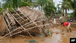 Residents begin cleaning up their homes in Cabanatuan, Philippines, October 20, 2015, two days after Typhoon Koppu battered northern Philippines and flooded Cabanatuan city and nearby provinces. 