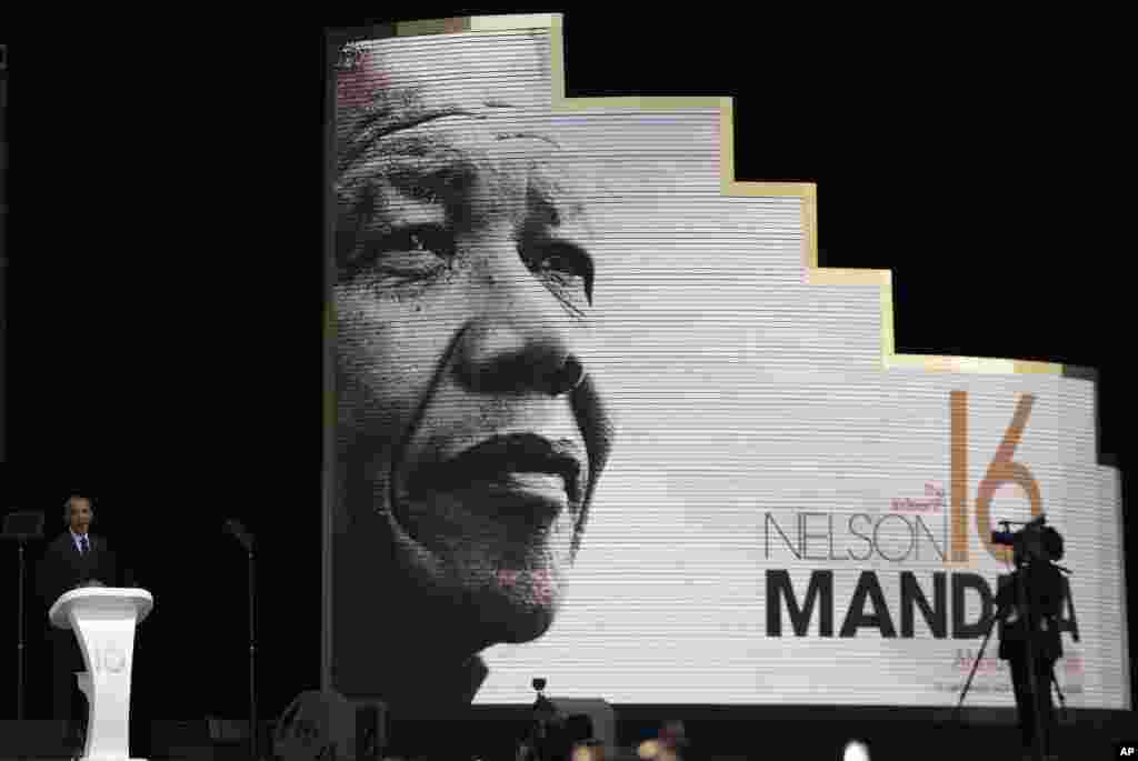 Former U.S. President Barack Obama, left, delivers a speech at the 16th Annual Nelson Mandela Lecture at Wanderers Stadium in Johannesburg, South Africa.