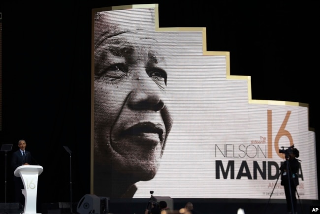 Former U.S. President Barack Obama, left, delivers his speech at the 16th Annual Nelson Mandela Lecture at the Wanderers Stadium in Johannesburg, South Africa, July 17, 2018.