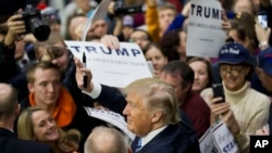 Republican presidential candidate, billionaire Donald Trump, gestures to the crowd as he signs autographs at a campaign event at Plymouth State University Sunday, Feb. 7, 2016, in Plymouth, New Hampshire.