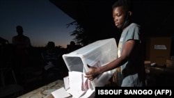 Des agents électoraux préparent les bulletins de vote pour le décompte des voix après les élections présidentielle et législatives à Ouagadougou, Burkina Faso, le 22 novembre 2020.