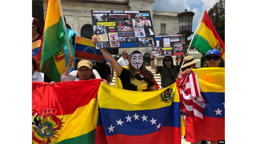Venezuelan expats are joined by Nicaraguans, Bolivians and others during a protest calling for freedom and democracy in Venezuela, in front of the building of the Organization of American States, in Washington, May 20, 2018.