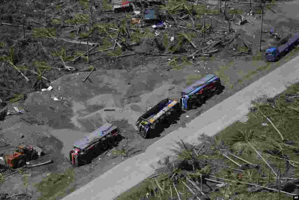 Cargo trucks lie on their side following last week's typhoon, in Leyte province, central Philippines, Nov. 15, 2013.