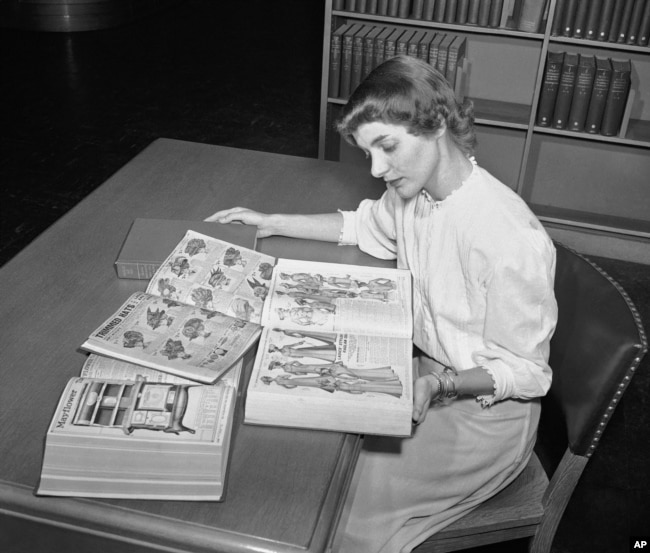 In an undated file photo, a librarian at the Chicago Public Library studies early Sears Roebuck catalogs in the library's collection in Chicago.