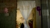 A curtain hangs in the doorway of what was the bedroom of Jhonny Godoy in La Vega slum of Caracas, Venezuela, Feb. 19, 2019. According to his family, two days after proclaiming his opposition to President Nicolas Maduro on Twitter, special police agents killed the 29-year-old.