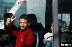 Migrants are seen in a bus as they are moved to a Turkish coastguard station after a failed attempt at crossing to the Greek island of Lesbos, in the Turkish coastal town of Dikili, Turkey, April 6, 2016.