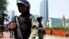 Indonesian anti-terror policemen stand guard in the business district in Jakarta, September 11, 2011. 