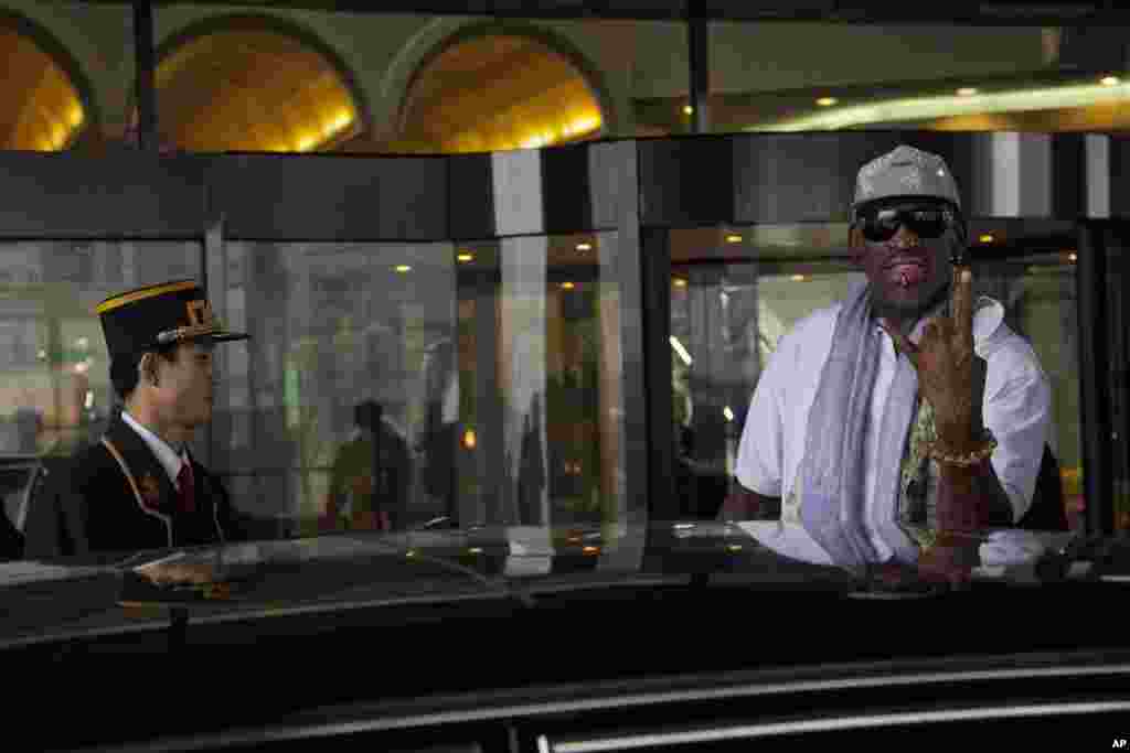 Dennis Rodman greets the media outside a Pyongyang hotel on his way to a basketball practice session between North Korean and U.S. players.