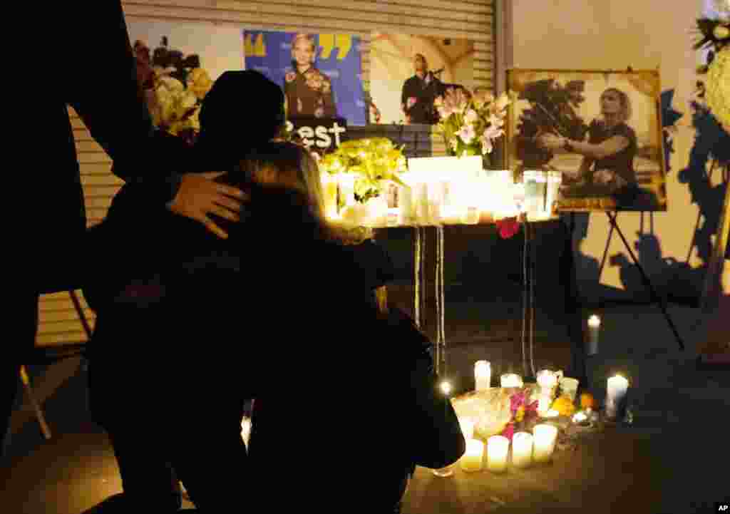Attendees embrace at a candlelight vigil for the late cinematographer Halyna Hutchins, Oct. 24, 2021, in Burbank, California.&nbsp;A prop firearm discharged last Thursday by actor Alec Baldwin, while producing and starring in a Western movie in Santa Fe, New Mexico, killed Hutchins and wounded director Joel Souza.