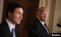 U.S. President Donald Trump, right, listens to Canadian Prime Minister Justin Trudeau during a joint news conference at the White House in Washington, Feb. 13, 2017.