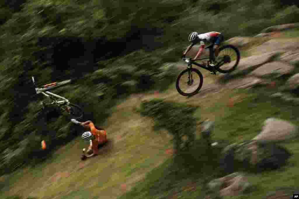 Mathieu van der Poel of the Netherlands tumbles on a downhill during the men&#39;s cross country mountain bike competition at the 2020 Summer Olympics in Izu, Japan.