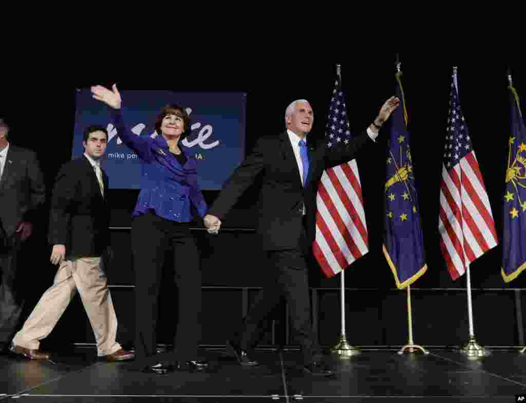 Indiana Republican gubernatorial candidate Mike Pence with his wife, Karen, wave to supporters at an Indiana Republican Party in Indianapolis, Nov. 6, 2012.