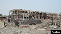 Damaged houses are seen one day after a Saudi-led air strike hit them in Yemen's western city of Mokha, July 26, 2015
