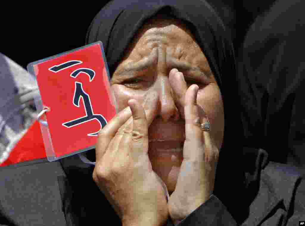 An Egyptian protester shouts anti-President Mohamed Morsi slogans and holds a red card that reads &quot;leave&quot; in Arabic during a protest in Tahrir Square, Cairo, June 28, 2013. 