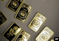 FILE - 10-gram gold bars lie on display in Dubai, United Arab Emirates.
