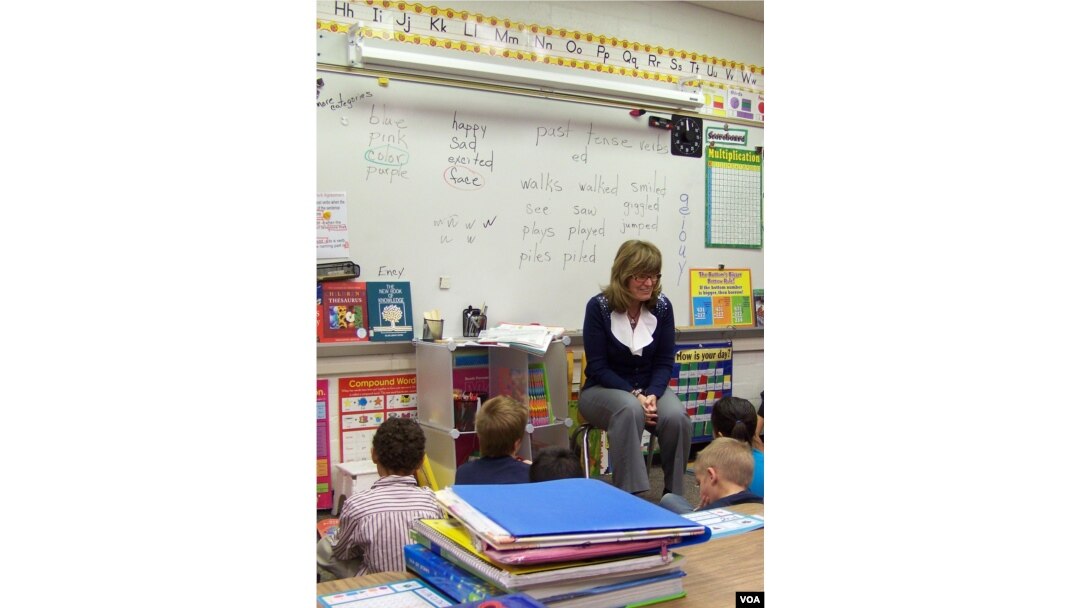 Teacher Sonja Pellerin with first and second-grade students at Hinkley School, which will soon close. (VOA/C. Richard)
