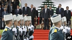 Lebanese President Michel Suleiman, fourth right, Lebanese Prime Minister Saad Hariri, second right, and Lebanese Parliament Speaker Nabih Berri, fifth right, attend military parade marking 67th anniversary of Lebanon's independence from France, in Beirut