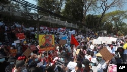 Anti-coup protesters gather outside U.S. Embassy in Yangon, Myanmar, Saturday, Feb. 13, 2021. 