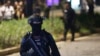 FILE - Officers stand guard at the site where an explosion that police said came from a firecracker, near the venue of the presidential candidates debate in Jakarta, Indonesia, Feb. 17, 2019. 