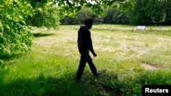 FILE - Sweden has long prided itself on offering refuge to those fleeing oppression in other parts of the world. This asylum-seeker is shown walking outside the Bergby Gard hotel, which houses asylum-seekers, north of Stockholm, June 6, 2014.