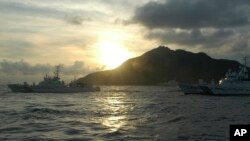 FILE - Japanese Coast Guard vessels sail near a group of disputed islands called Diaoyu by China and Senkaku by Japan.