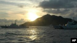 Japanese Coast Guard vessels sail near a group of disputed islands called Diaoyu by China and Senkaku by Japan, Aug. 18, 2013. 