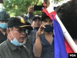 មន្ត្រី​សន្តិសុខ​ប្រាប់​ឲ្យ​ក្រុម​អ្នកតវ៉ា​ឲ្យ​ឈប់​ដើរ​ហែក្បួន ដោយ​គ្មាន​ការ​អនុញ្ញាត​ពី​រដ្ឋបាល​រាជធានី​ភ្នំពេញ។ (ហ៊ុល រស្មី​/វីអូអេ)​