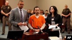 FILE - Dr. Larry Nassar, 54, appears in court for a plea hearing in Lansing, Mich., Nov. 22, 2017. Nasser, a sports doctor accused of molesting girls, was sentenced Dec. 7 to 60 years in prison for possessing thousands of images of child pornography.
