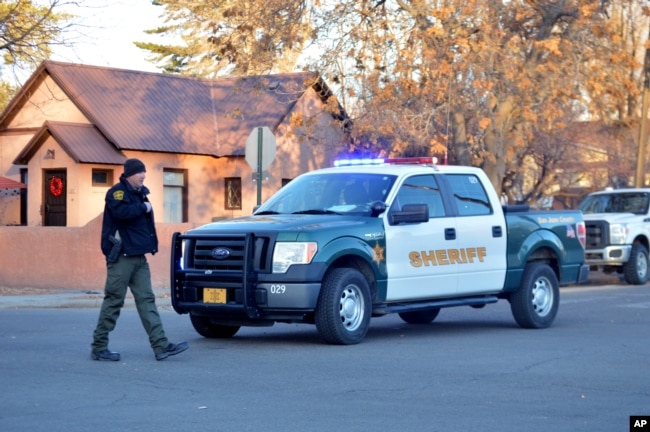 Sheriff's deputy at the entrance to Aztec High School in Aztec, New Mexico, following a deadly shooting on campus, Dec. 7, 2017.